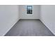 Empty room featuring neutral carpet, a window, and gray walls at 1424 Elk Falls Dr, Wendell, NC 27591