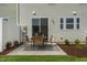 Outdoor patio features a bistro set on a concrete slab with views of the green space at 144 Kobus Ct, Garner, NC 27529