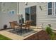 Cozy patio area featuring a modern outdoor table and chairs on a patterned rug at 144 Kobus Ct, Garner, NC 27529