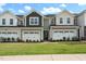 Beautiful townhome exterior with individual garages, manicured lawn, and a welcoming facade at 148 Kobus Ct, Garner, NC 27529
