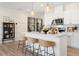 Stylish kitchen with a center island featuring barstool seating, modern lighting and stainless appliances at 148 Kobus Ct, Garner, NC 27529