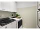 Functional laundry room with modern washer and dryer, ample storage, and clean design at 148 Kobus Ct, Garner, NC 27529