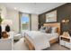 Cozy primary bedroom with a wood bed frame, neutral tones, and natural light from the window at 148 Kobus Ct, Garner, NC 27529