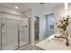 Bright bathroom with glass shower, white cabinets and countertop at 152 Kobus Ct, Garner, NC 27529