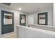 Upstairs hallway with modern artwork and white railings at 152 Kobus Ct, Garner, NC 27529