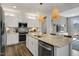 Modern kitchen featuring white cabinets, a stainless steel dishwasher, and a center island at 152 Kobus Ct, Garner, NC 27529