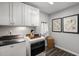 Bright laundry room with modern machines, white cabinetry, and stylish decor at 152 Kobus Ct, Garner, NC 27529