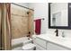 Cozy bathroom with tub and shower, and vanity with white cabinets at 198 Gentry Dr, Pittsboro, NC 27312