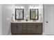 Bathroom featuring double vanity with dark wood cabinets, granite countertop and decorative lighting at 198 Gentry Dr, Pittsboro, NC 27312