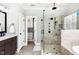 Bathroom featuring a large glass enclosed shower, soaking tub and dark wood cabinetry at 198 Gentry Dr, Pittsboro, NC 27312