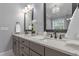 Bathroom featuring double vanity with dark wood cabinets, granite countertop and decorative lighting at 198 Gentry Dr, Pittsboro, NC 27312