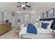 Comfortable bedroom featuring a ceiling fan, carpet, and large bed with white and blue patterned linen at 198 Gentry Dr, Pittsboro, NC 27312