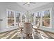 Sunlit breakfast nook surrounded by windows, complete with modern chairs and a glass table at 198 Gentry Dr, Pittsboro, NC 27312