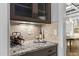 Convenient butler's pantry featuring granite countertops, wine storage, and glass-front cabinets at 198 Gentry Dr, Pittsboro, NC 27312