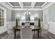 Elegant dining room with decorative chandelier, wall sconces, and a table seating for six at 198 Gentry Dr, Pittsboro, NC 27312