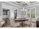Chic dining room boasts stylish lighting, wainscoting, and a view to the front entry at 198 Gentry Dr, Pittsboro, NC 27312