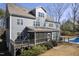 Beautiful home exterior featuring a screened porch, deck, and lush landscaping with a pool at 198 Gentry Dr, Pittsboro, NC 27312