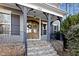 Inviting front entrance with a beautiful double door, stone steps and decorative wreaths at 198 Gentry Dr, Pittsboro, NC 27312