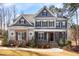 Charming two-story home featuring stone and shingle accents, complemented by a well-manicured lawn and landscaped garden at 198 Gentry Dr, Pittsboro, NC 27312