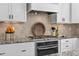 Stylish kitchen featuring granite countertops, modern appliances, and a tile backsplash at 198 Gentry Dr, Pittsboro, NC 27312