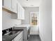 Well-equipped laundry room with a sink, cabinets, and modern appliances, offering convenience at 198 Gentry Dr, Pittsboro, NC 27312