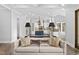 Comfortable living room with hardwood flooring, open-concept views of the kitchen, and natural light at 198 Gentry Dr, Pittsboro, NC 27312