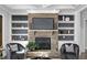 Cozy living room with stone fireplace, built-in shelving, and comfortable seating at 198 Gentry Dr, Pittsboro, NC 27312