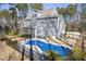 Aerial view of a home's backyard showcasing a pool and spa at 198 Gentry Dr, Pittsboro, NC 27312