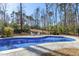 Sparkling private pool surrounded by lush greenery, ideal for relaxation and summer fun at 198 Gentry Dr, Pittsboro, NC 27312
