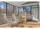 Relaxing screened porch with rocking chairs and a wooded view, perfect for enjoying the outdoors at 198 Gentry Dr, Pittsboro, NC 27312