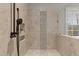 Shower with dual shower heads, tile surround with decorative band, and a built-in shower caddy at 198 Gentry Dr, Pittsboro, NC 27312