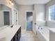 This primary bathroom features a tub, walk-in shower and double vanity at 201 Silver Creek Dr, Clayton, NC 27520
