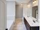 This bathroom features double sinks, a soaking tub, a large mirror, and neutral colored tile flooring at 201 Silver Creek Dr, Clayton, NC 27520