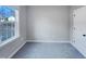 This bedroom has neutral walls, a large window, and a door at 201 Silver Creek Dr, Clayton, NC 27520