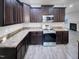 This kitchen has dark cabinets and stainless steel appliances at 201 Silver Creek Dr, Clayton, NC 27520
