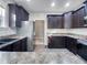 This kitchen includes dark cabinets, stainless steel appliances, and hard surface countertops at 201 Silver Creek Dr, Clayton, NC 27520