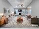 Bright, staged living room featuring a vaulted ceiling, recessed lighting, fireplace, ceiling fan, and hardwood flooring at 201 Silver Creek Dr, Clayton, NC 27520