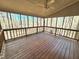Relaxing screened porch with a ceiling fan, string lights and wooded scenery at 2024 Fox Den, Clayton, NC 27527