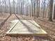 Backyard view shows leveled square area perfect for outdoor play at 2024 Fox Den, Clayton, NC 27527