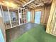 Partially finished basement with work area, storage, and walkout door at 2024 Fox Den, Clayton, NC 27527