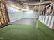 Unfinished basement with painted foundation walls, exposed ceiling and added turf at 2024 Fox Den, Clayton, NC 27527