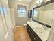 Bright bathroom features a single vanity, framed mirror, window, and shower-tub combo at 2024 Fox Den, Clayton, NC 27527