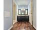 Bathroom with double sink vanity, wood floors, and neutral color scheme at 2024 Fox Den, Clayton, NC 27527