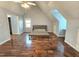 Spacious bedroom with hardwood floors, a ceiling fan, and natural light from the windows at 2024 Fox Den, Clayton, NC 27527