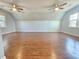 Bright bonus room showcasing hardwood floors, vaulted ceilings, and multiple windows at 2024 Fox Den, Clayton, NC 27527