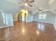 Large bonus room with hardwood floors, neutral paint, ceiling fans, and ample natural light at 2024 Fox Den, Clayton, NC 27527