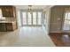 Bright dining area with many windows overlooking the outdoors, adjacent to the kitchen and deck at 2024 Fox Den, Clayton, NC 27527