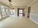 Dining area with many windows overlooking the outdoors, adjacent to the kitchen and entryway at 2024 Fox Den, Clayton, NC 27527
