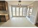 Eat-in kitchen features modern lighting, lots of windows with outdoor views, and a sliding door to a screened deck at 2024 Fox Den, Clayton, NC 27527