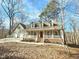Beautiful home with a covered front porch and inviting curb appeal at 2024 Fox Den, Clayton, NC 27527